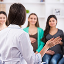 Medical providing teaching a group of pregnant women.